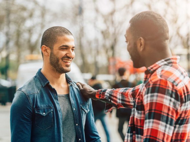 A man talks with his friend and offers encouragement