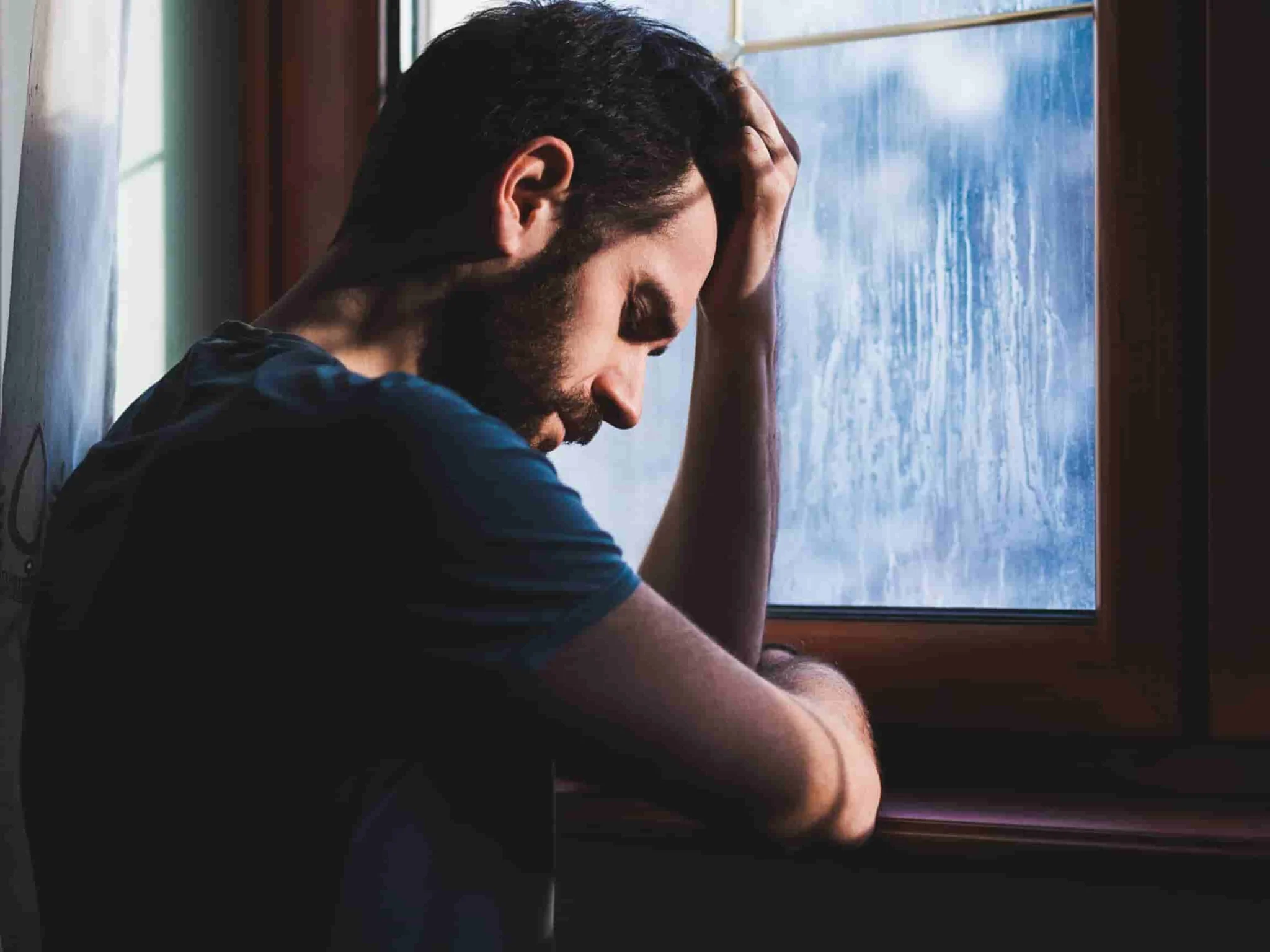 A man puts his head in his hands