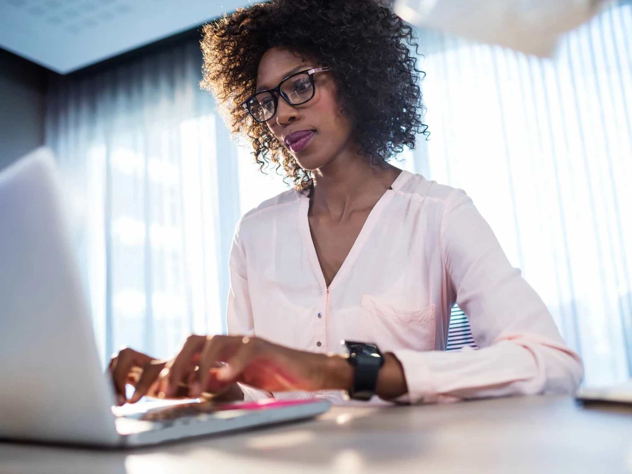 A woman researches eating disorder treatment programs on her computer