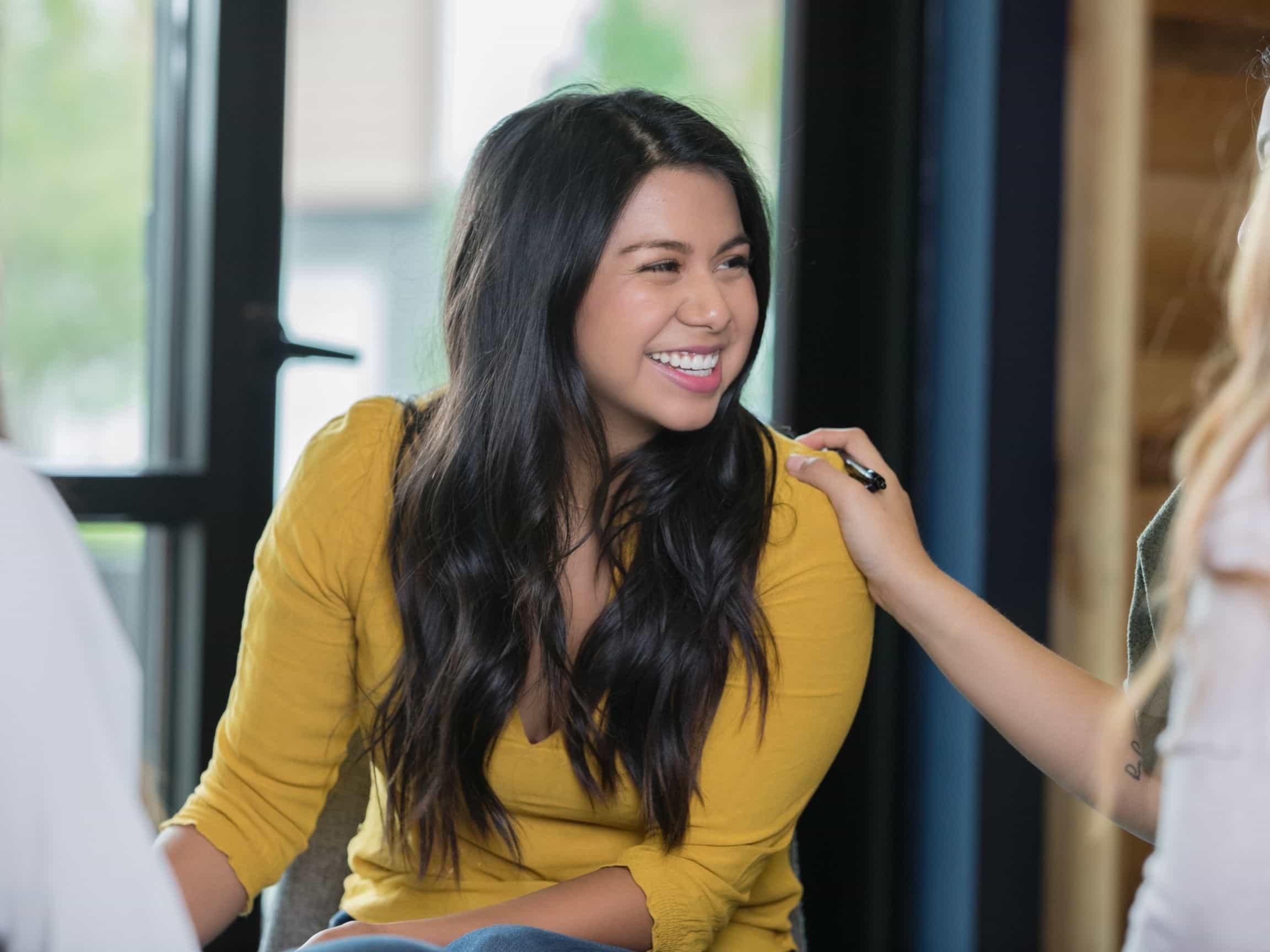 What Is Eating Disorder Treatment Like A woman participates in group therapy at an eating disorder treatment center