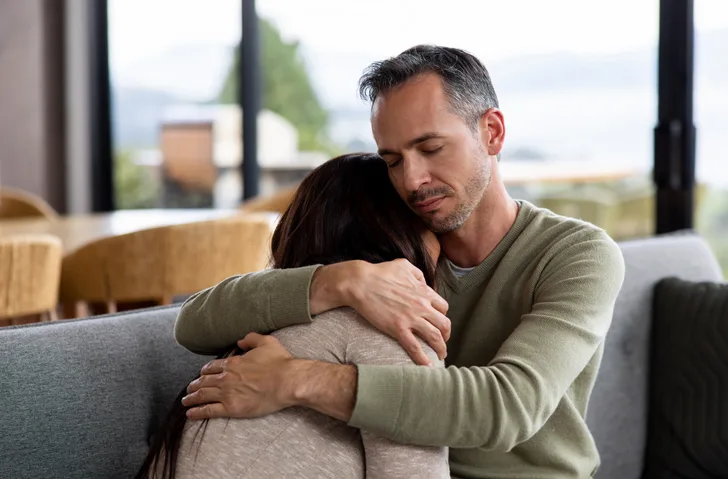 Loving man comforting his wife grieving husband consoling his wife who's struggling with an eating disorder