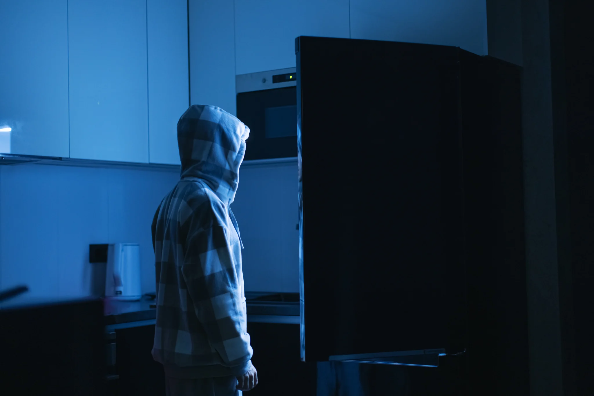 Man near refrigerator at night