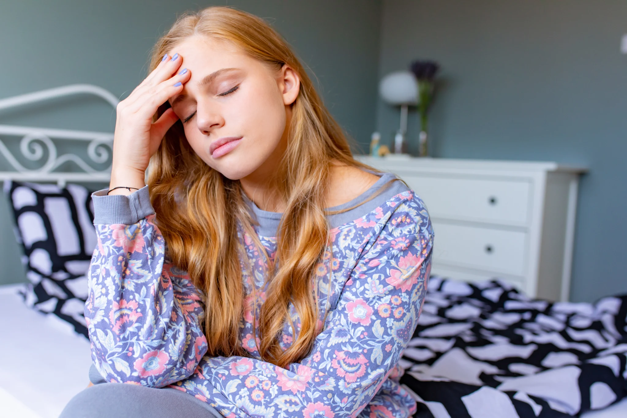 Lonely young woman at home feeling sad