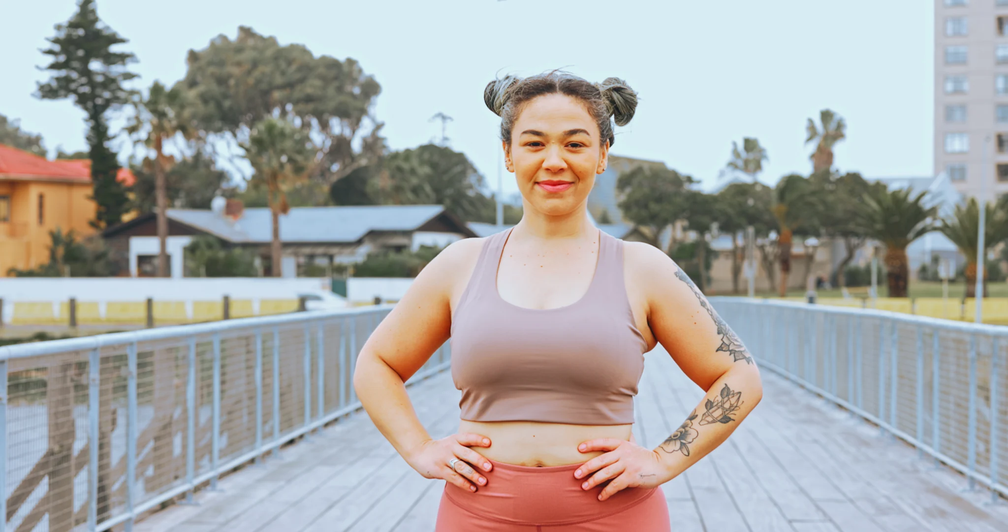 Plus size woman, weightloss and fitness in city health workout, wellness training or cardio exercise. Portrait, smile and happy runner with normal body, sports goals or marathon motivation on bridge