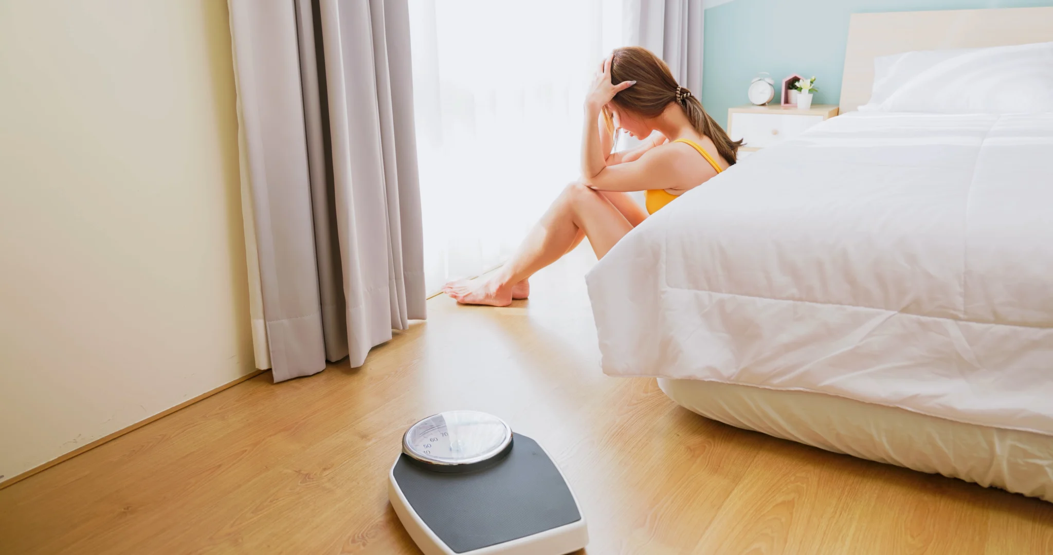 asian woman is frustrated over gaining weight and depressed at home